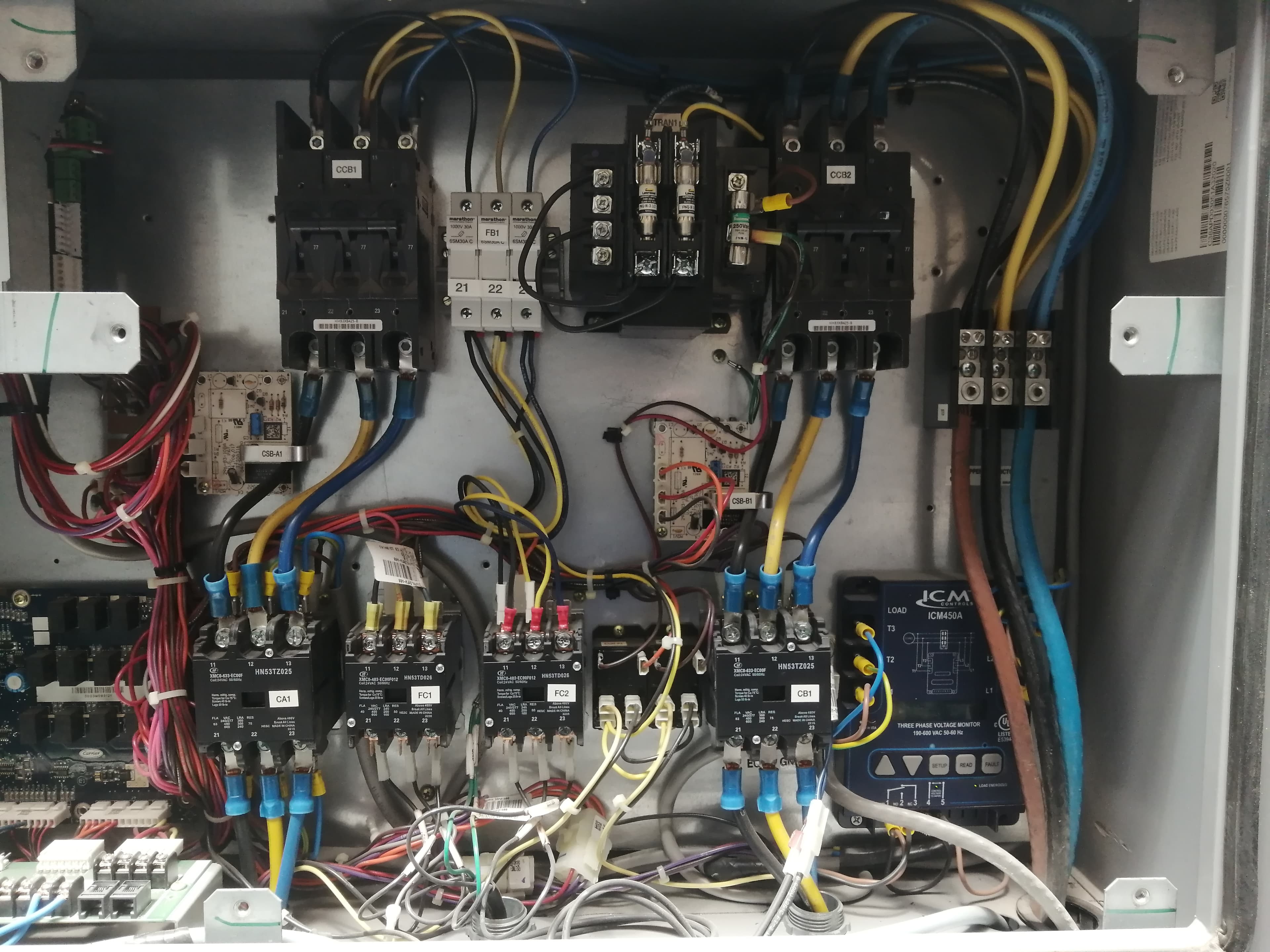 Complex electrical control panel with circuit breakers, contactors, and organized wiring for industrial machinery.